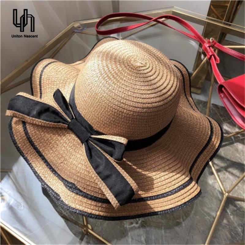 UN หมวกปีกกว้างผู้หญิงผูกโบว์ฤดูร้อนใหม่2021 หมวกผู้หญิงกันแดดแฟชั่น หมวกเที่ยวทะเล